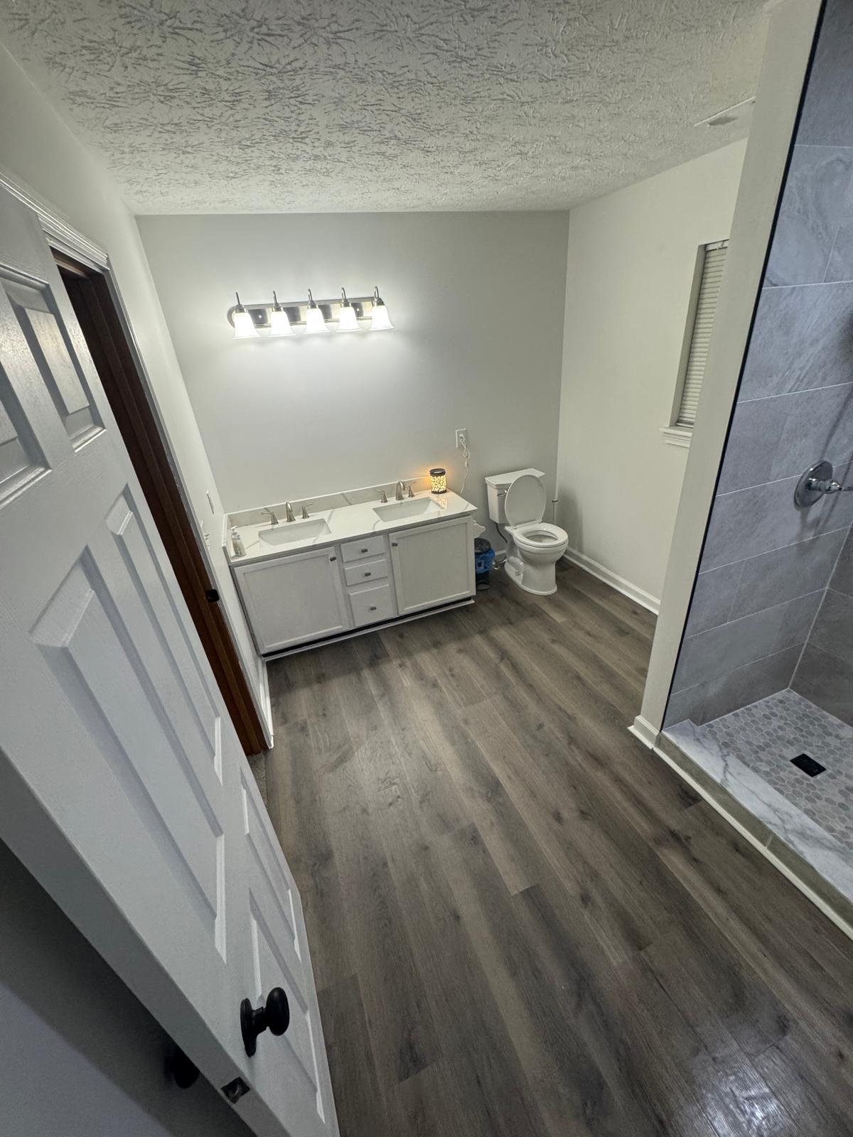 Bathroom remodel with modern fixtures by A Kingdom Construction Co.