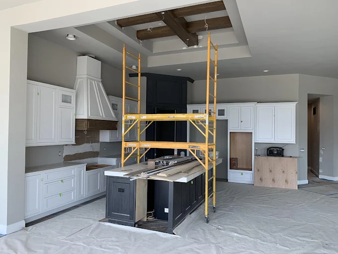 Kitchen renovation with custom drywall and exposed beams under construction