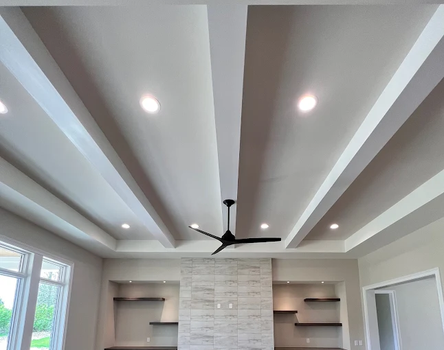 Coffered ceiling with recessed lighting and smooth drywall finish
