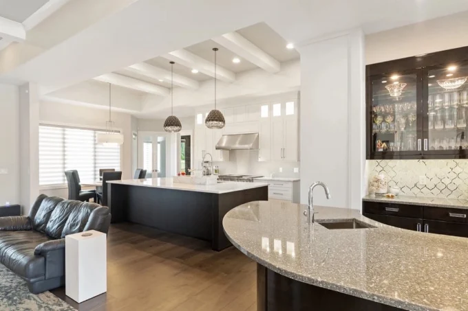 Finished open concept kitchen with smooth drywall ceilings and custom cabinetry