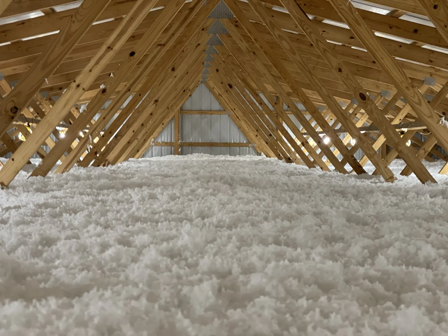 Pristine white blown-in insulation in a large attic space