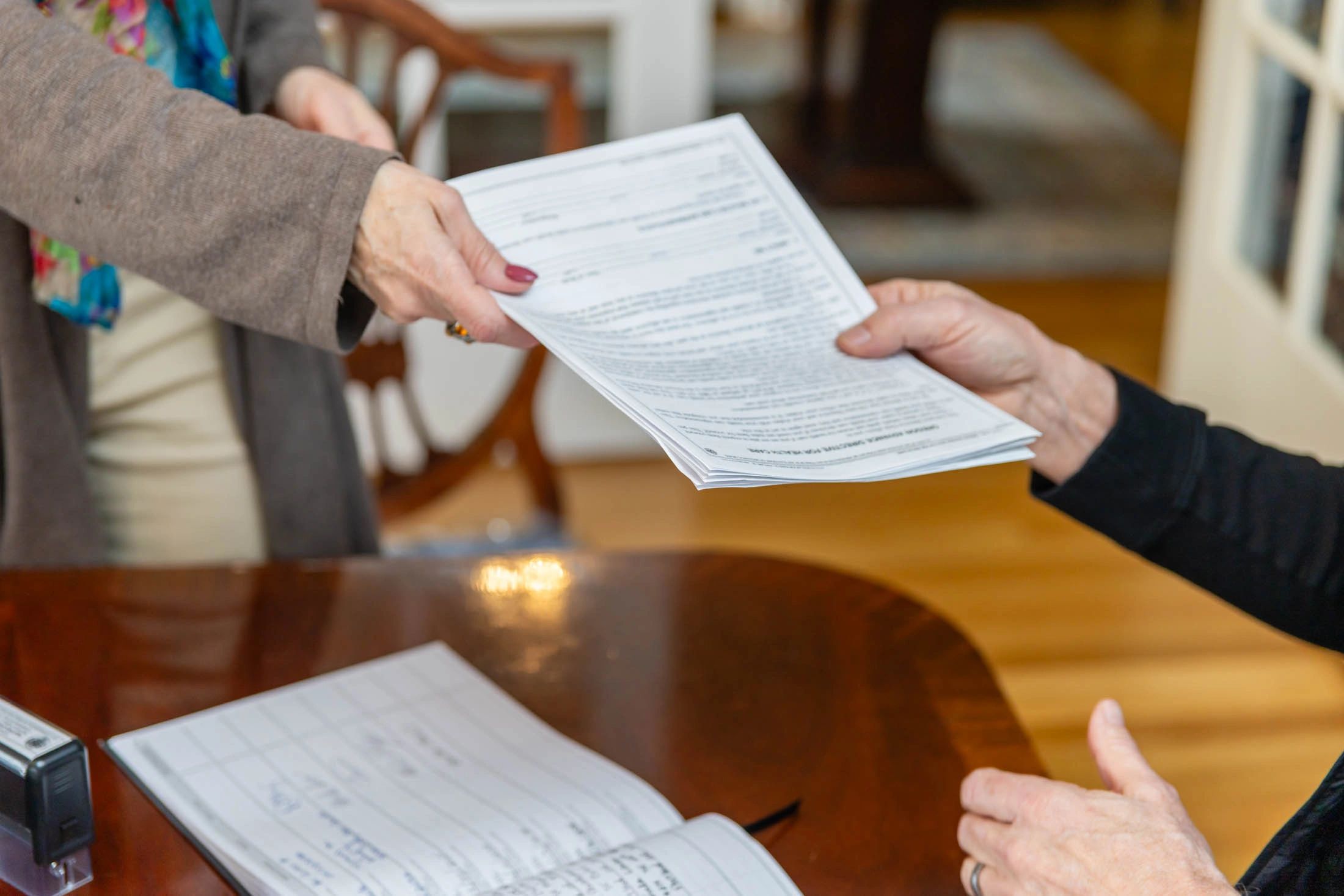 Notary handing documents to client