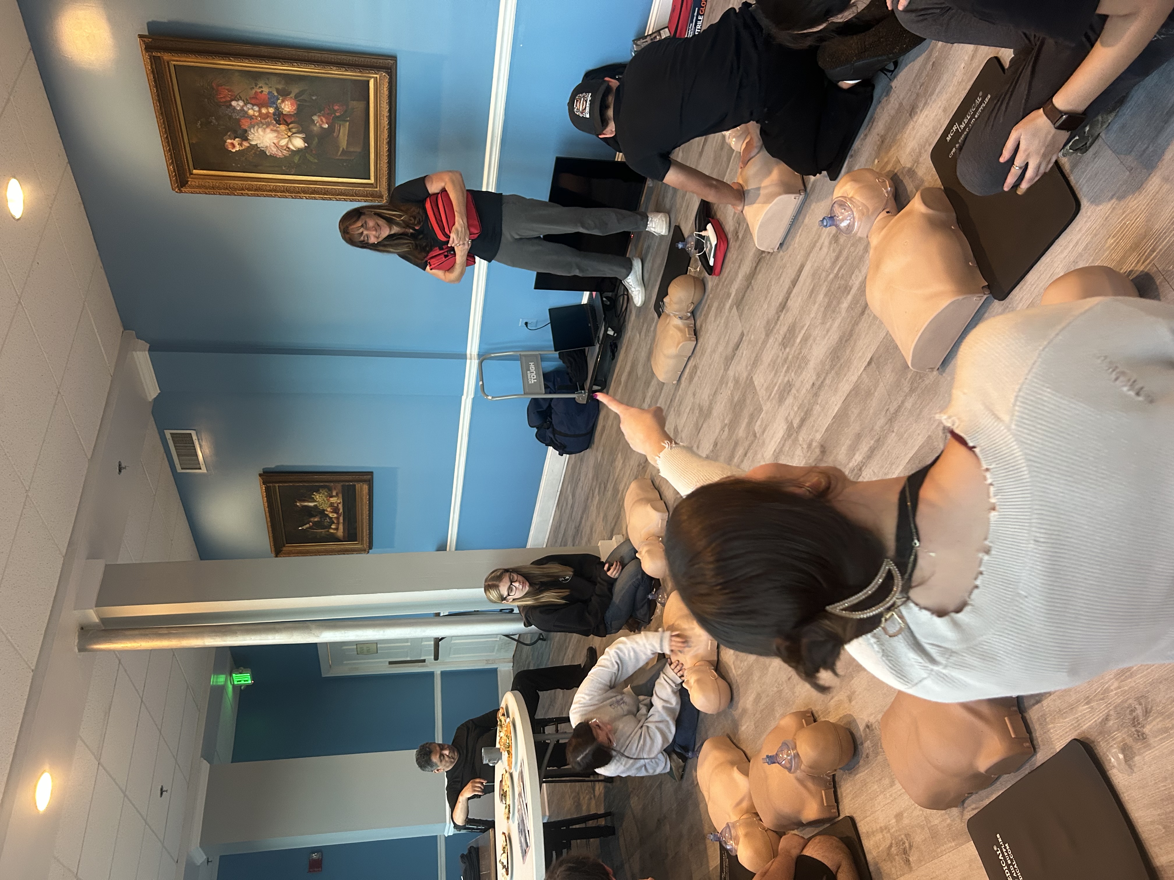 Class practicing CPR on mannequins