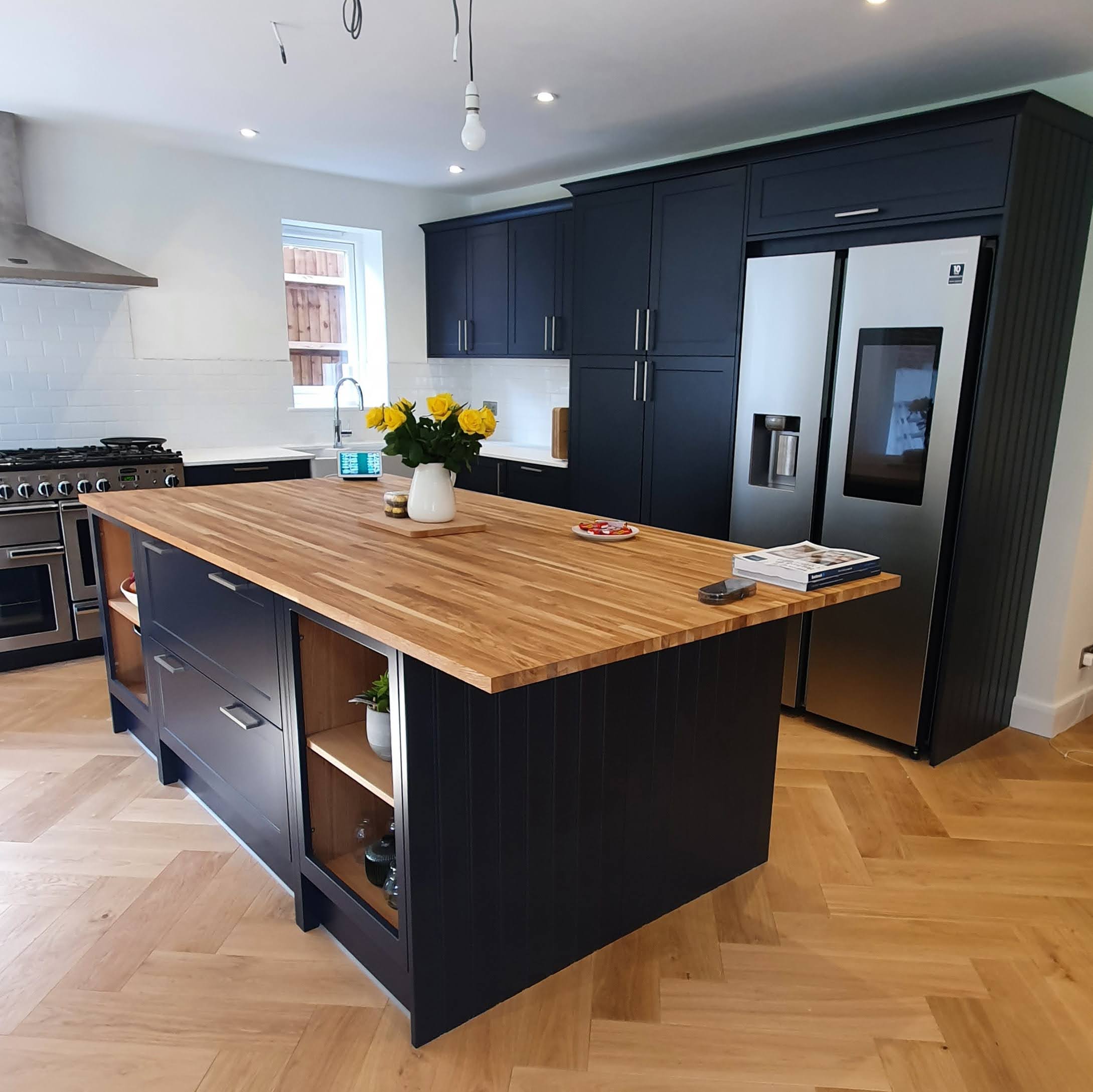 Large bespoke kitchen island with solid oak block worktop and navy shaker cabinets