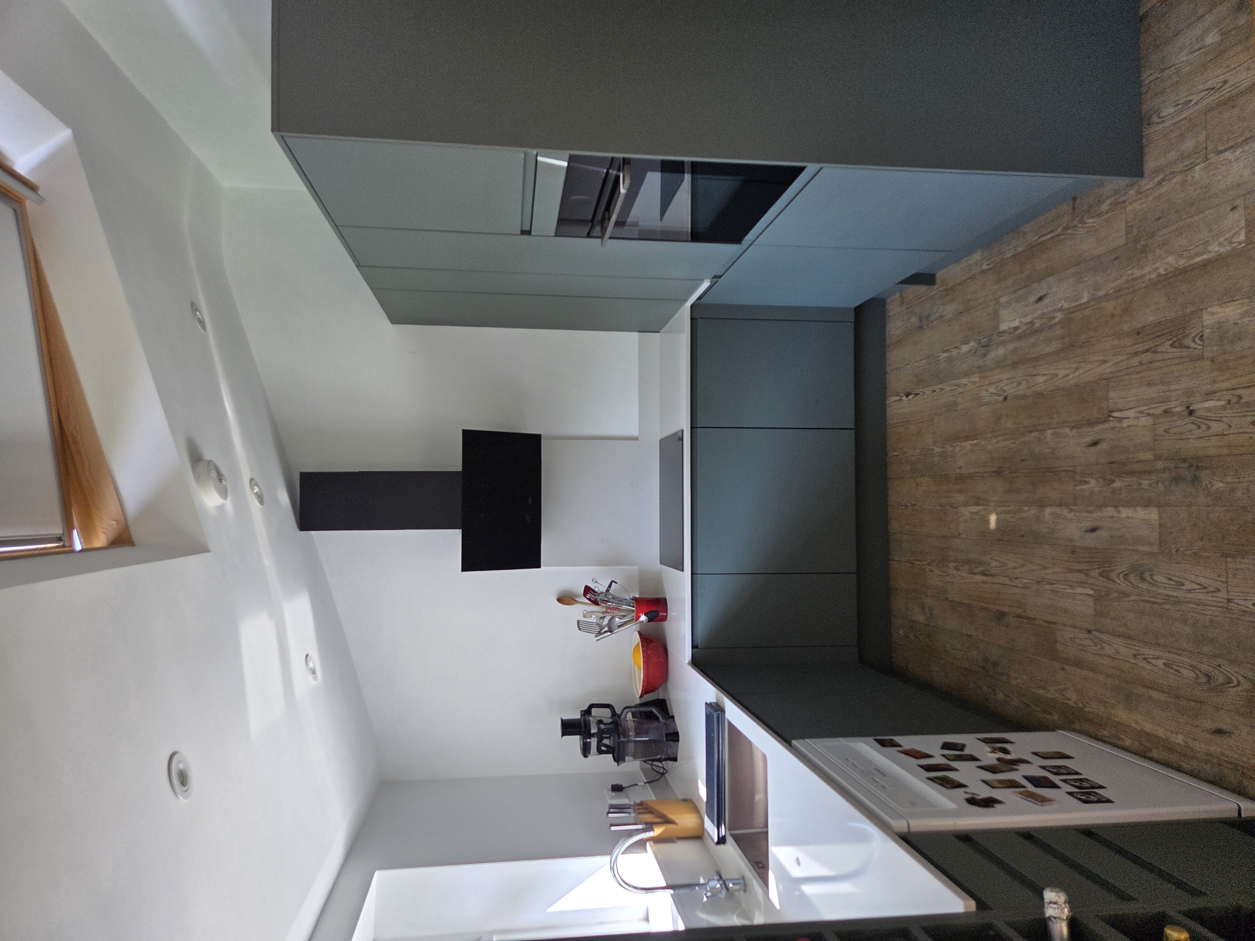 Contemporary handleless green kitchen design with sleek modern lines and minimalist finish