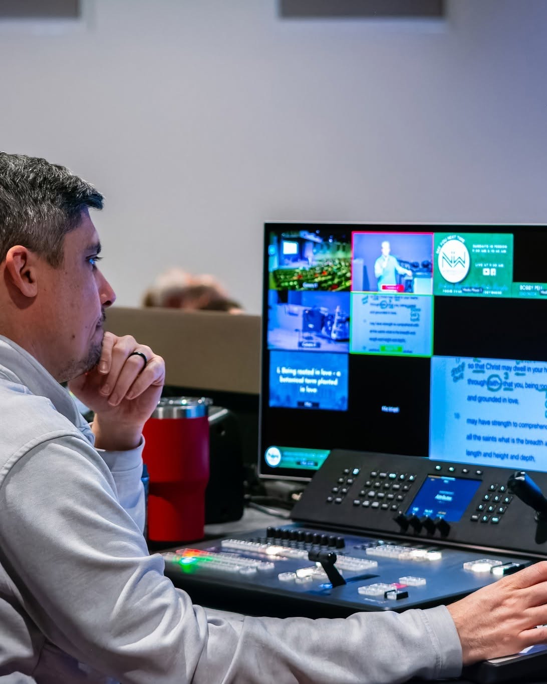 Audio/Visual volunteer at the production desk during a Sunday service