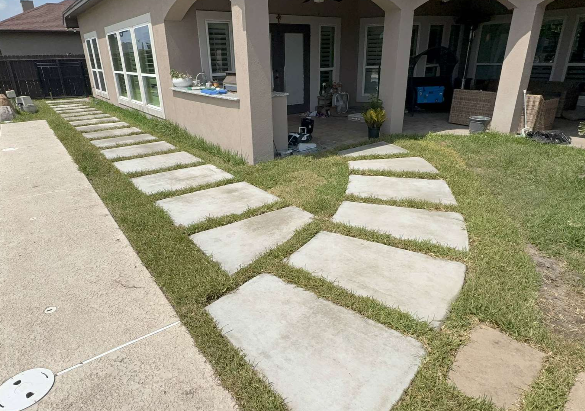 Finished concrete stepping stone walkway with grass