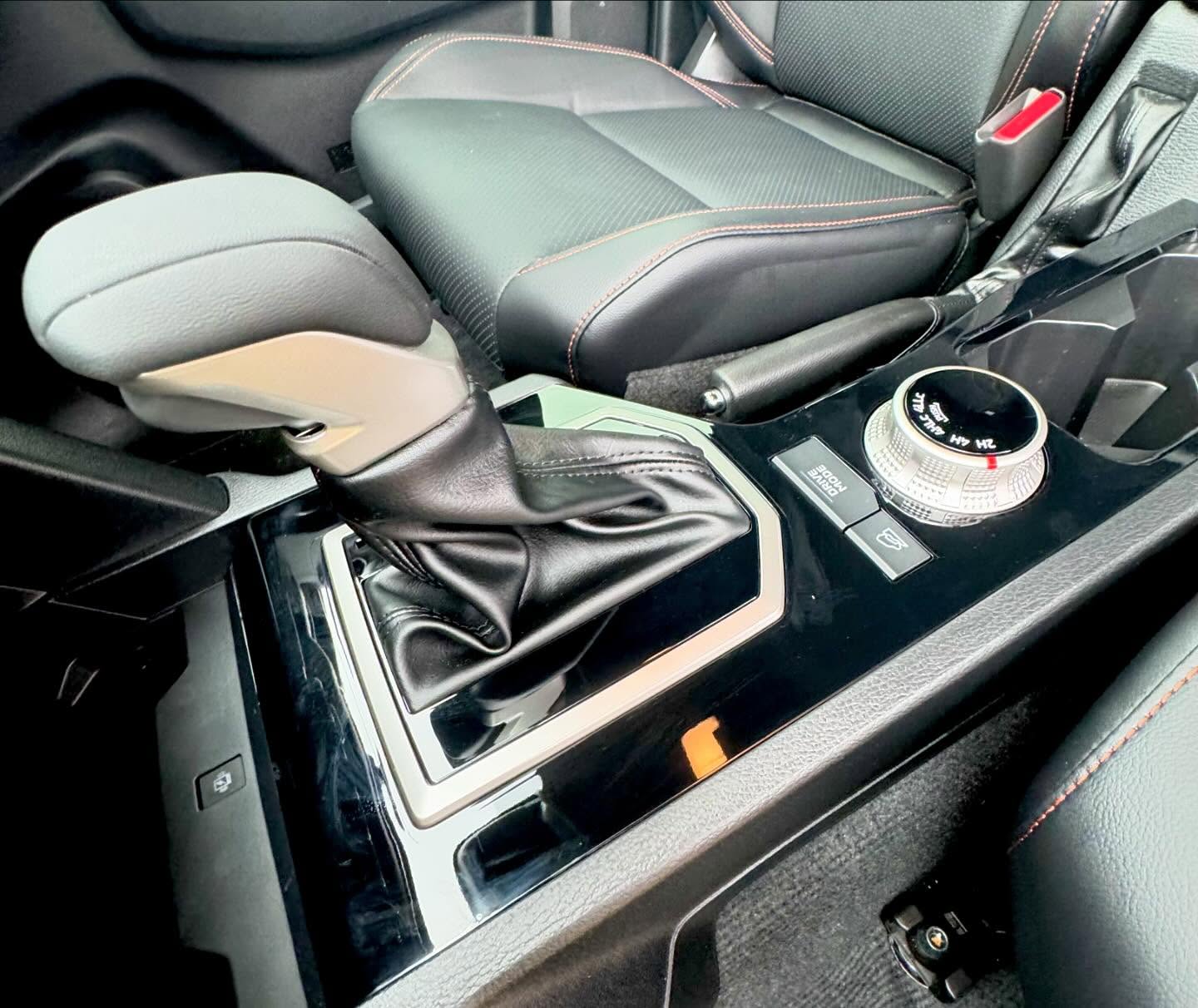 Car interior center console wrapped in gloss black by Master Wraps Townsville