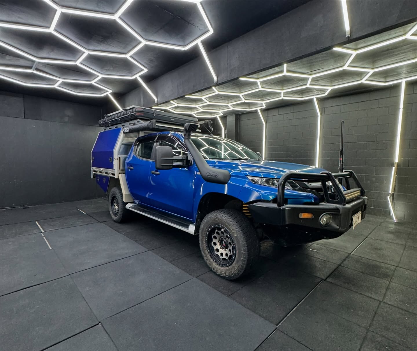 Blue dual cab ute with canopy front view inside the Master Wraps studio