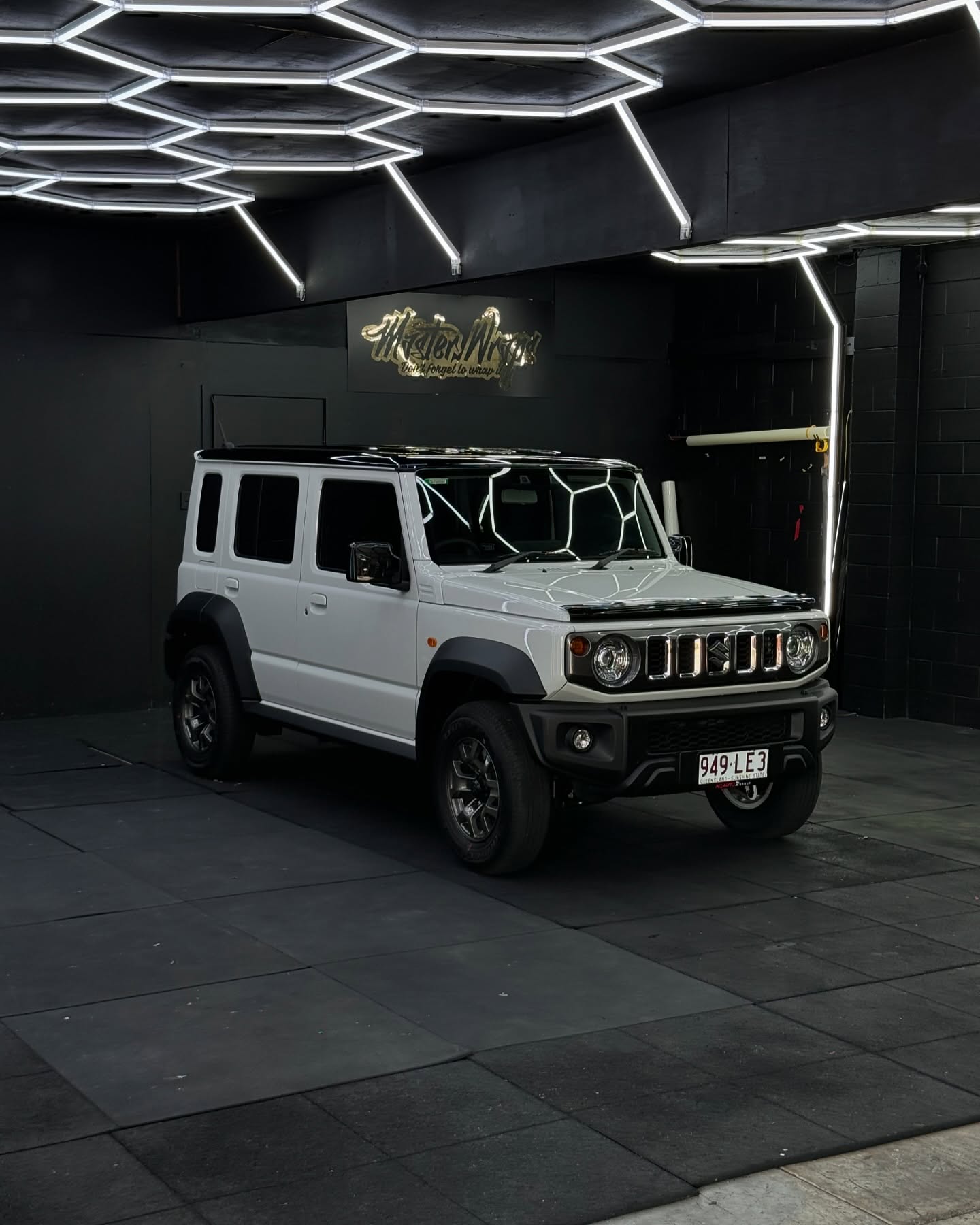 White Suzuki Jimny front view with custom blackout accents