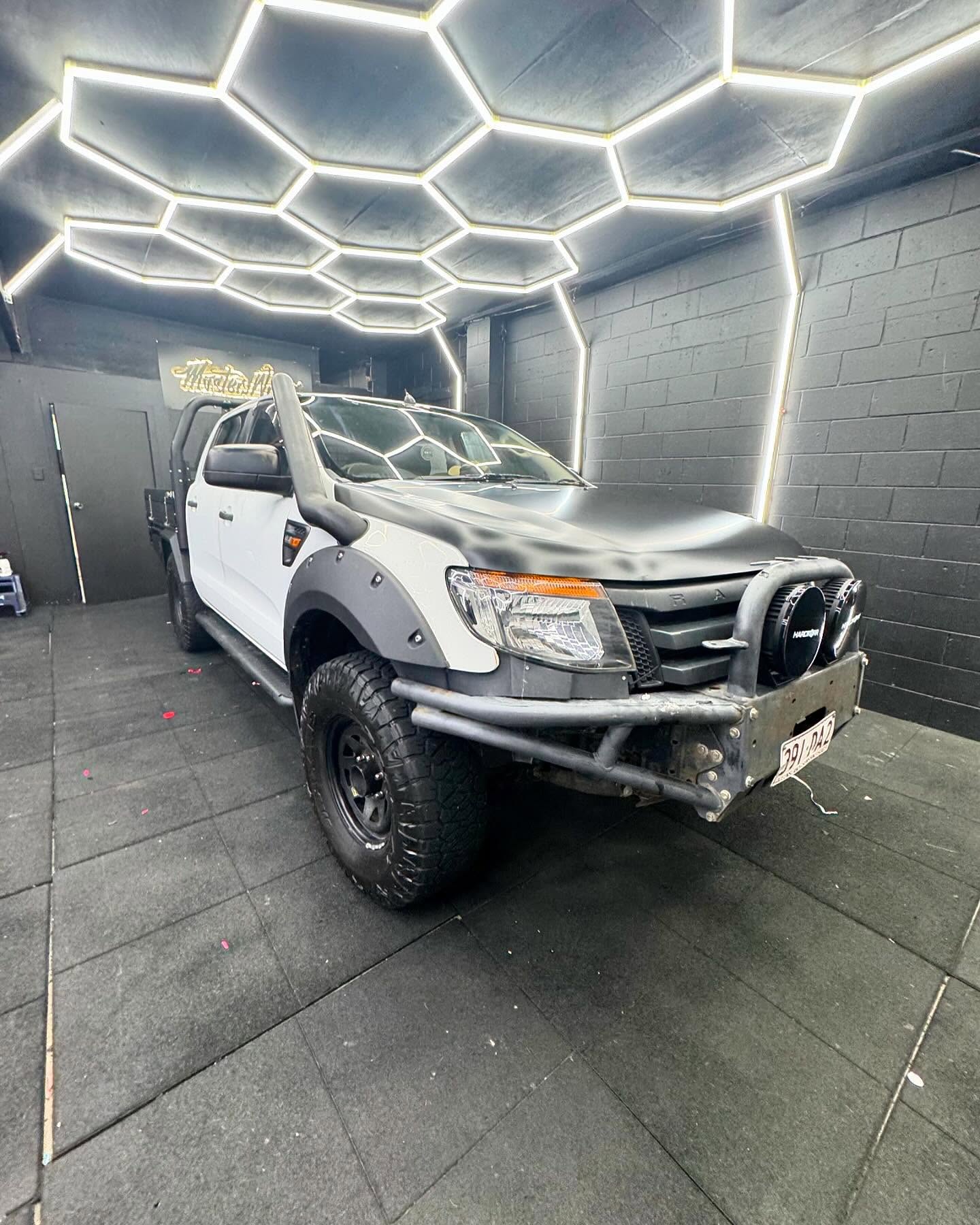 White and black dual cab ute with snorkel inside the Master Wraps studio