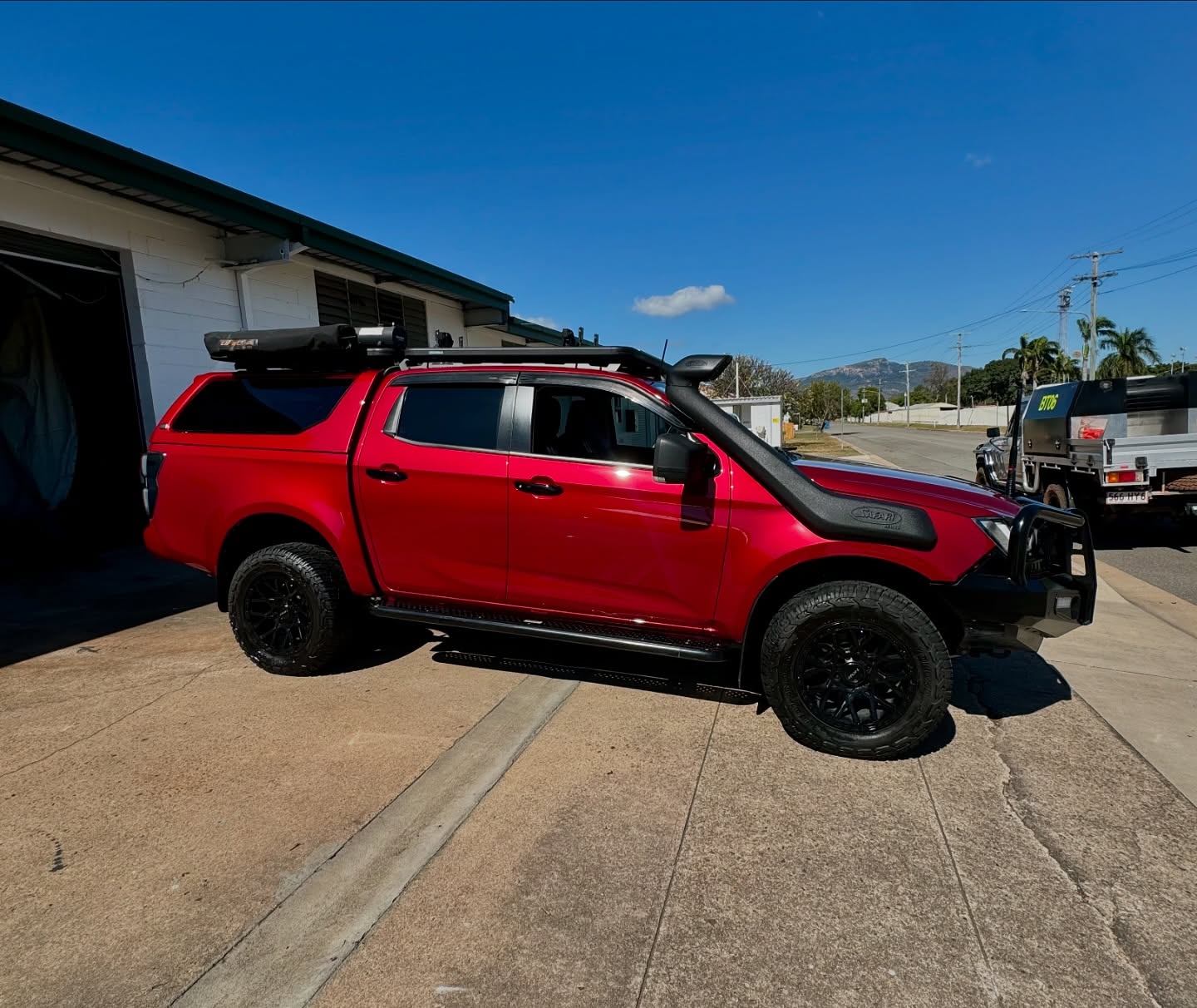 Gloss red dual cab ute parked outside Master Wraps Townsville