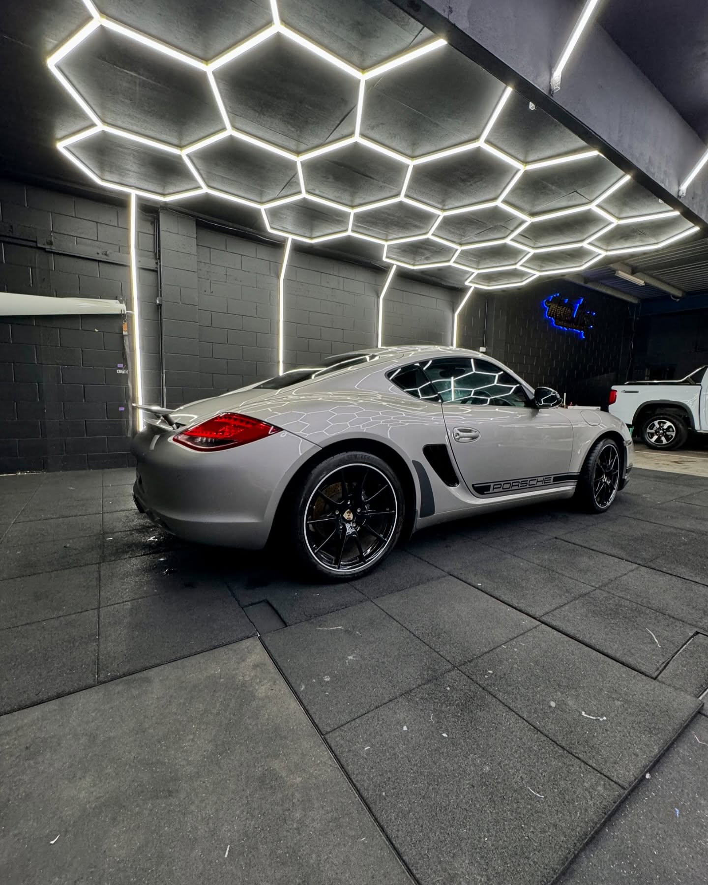 Silver Porsche sports car rear quarter view showing premium wrap finish