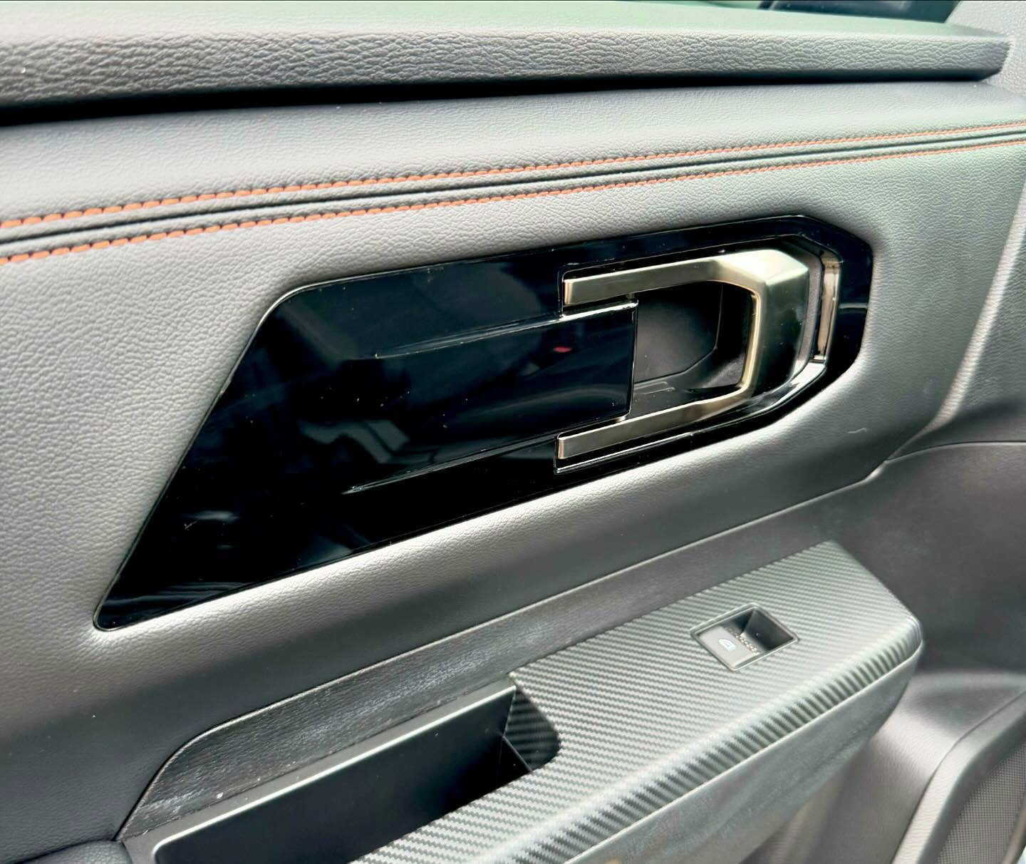 Car interior door handle wrapped in gloss black by Master Wraps Townsville