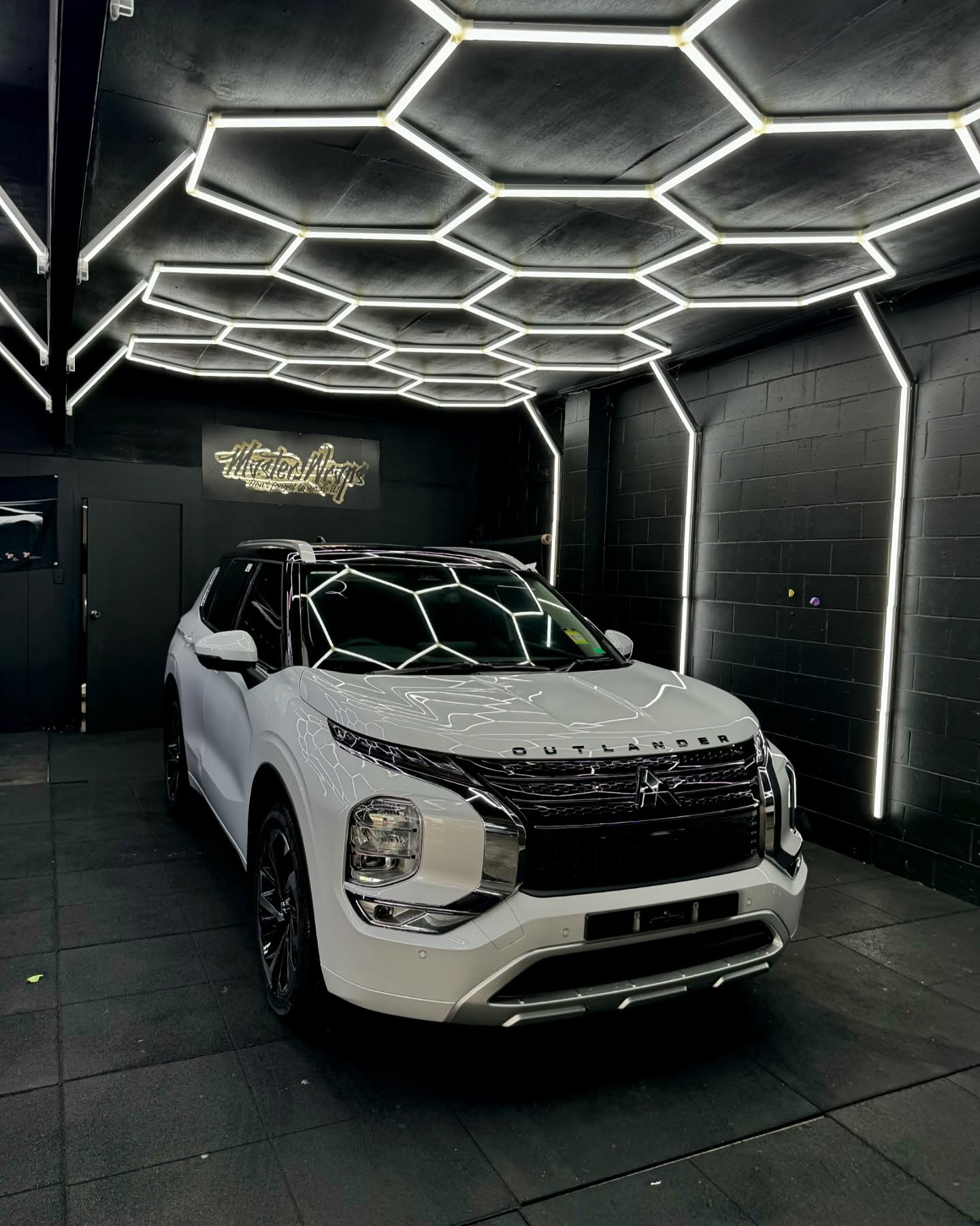 White Mitsubishi Outlander front view showing premium wrap finish