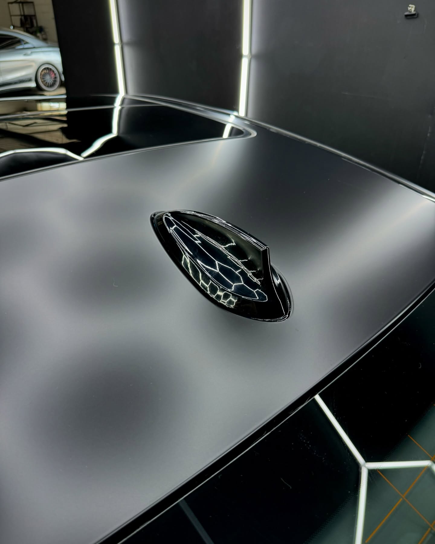 Close up of a black car roof antenna showing premium finish