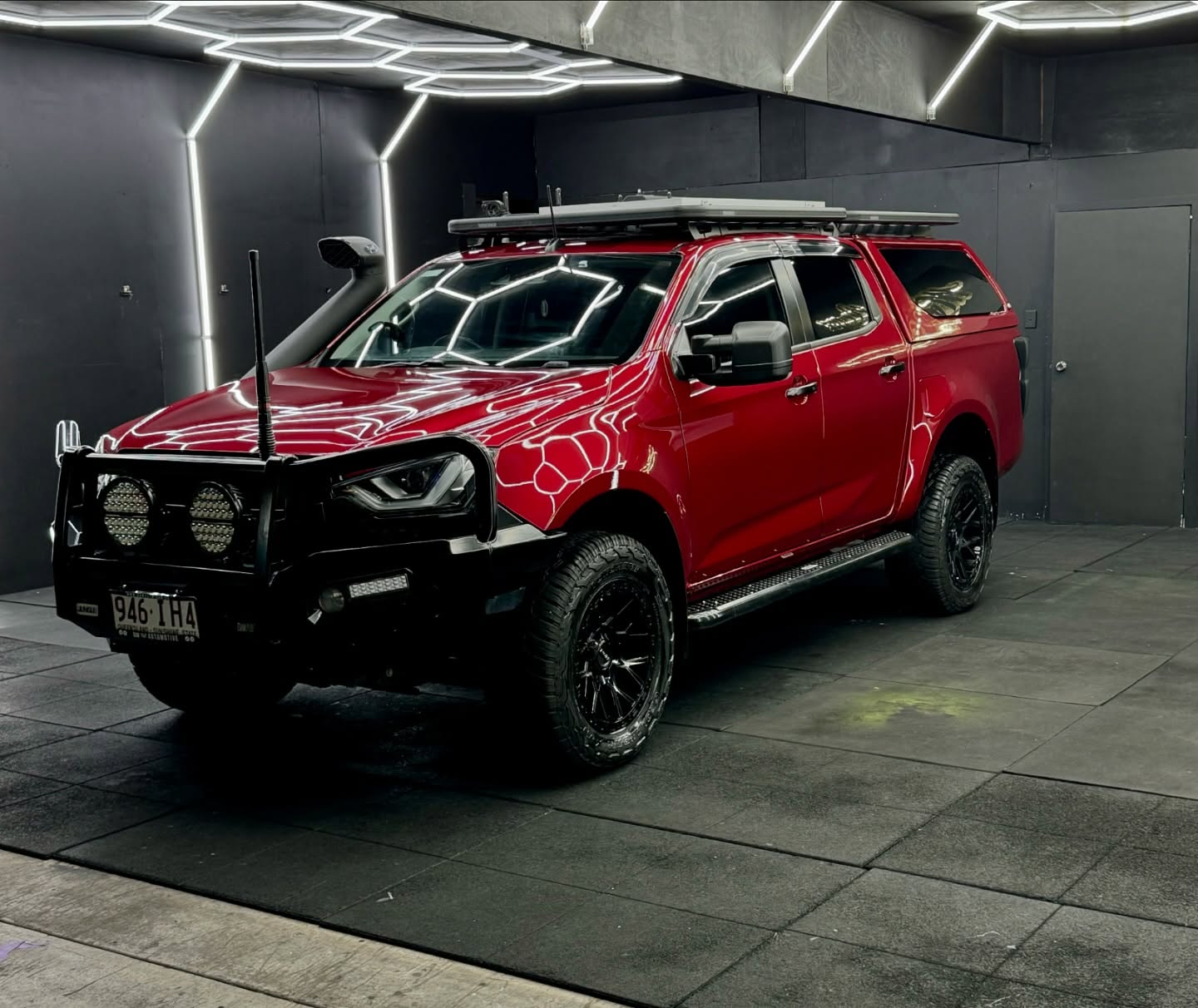 Gloss red dual cab ute with custom lighting inside the Master Wraps studio