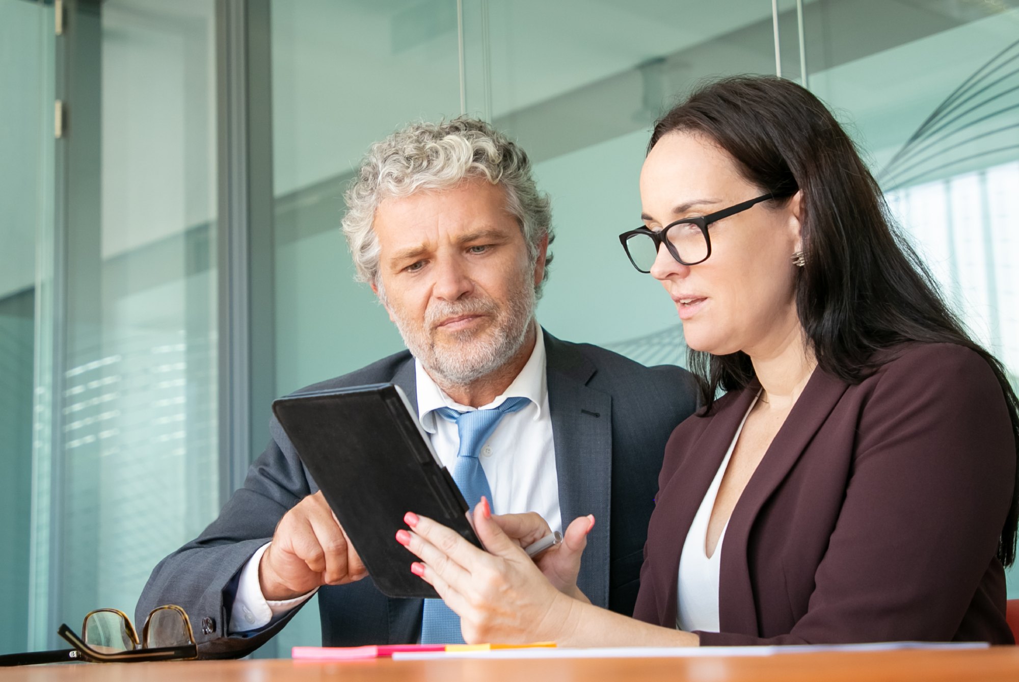 Corporate fraud investigation professionals reviewing evidence