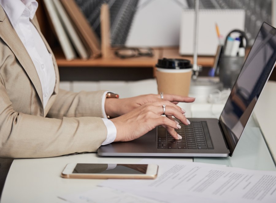 Case notes and laptop on desk