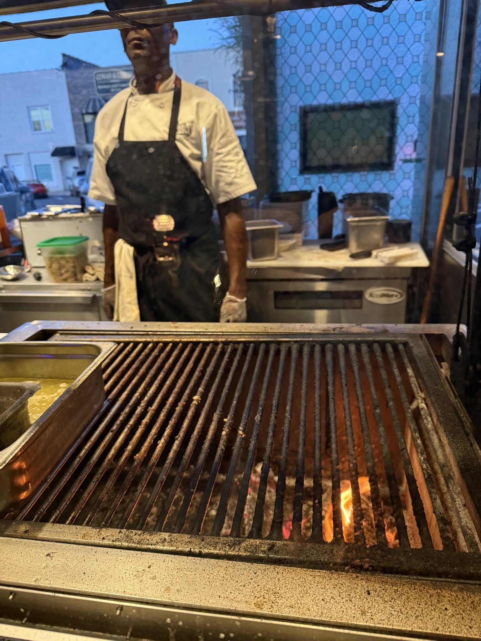 Chef at the live-oak wood fire grill at Poor Parson's