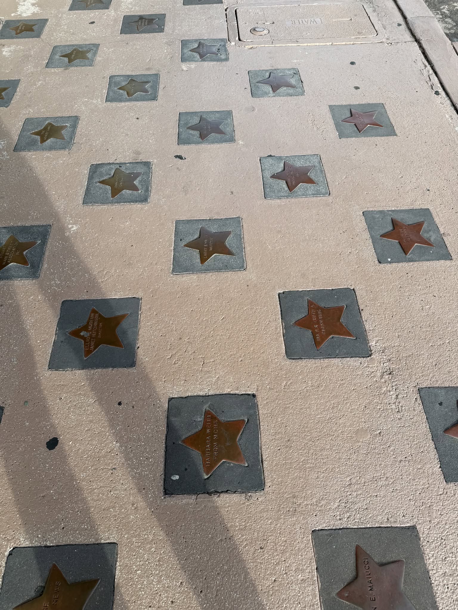 Bronze stars embedded in the sidewalk outside the Lyric Theatre