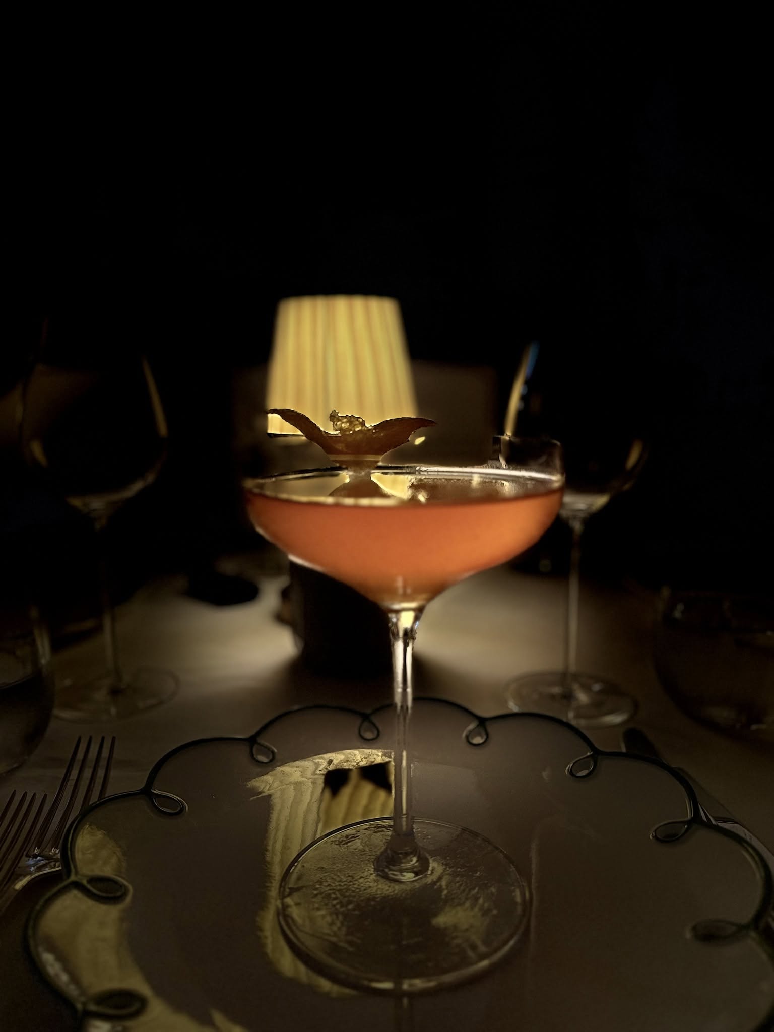 Coastal Rose Gentian cocktail at Coco's - elegant pink cocktail in coupe glass with citrus garnish