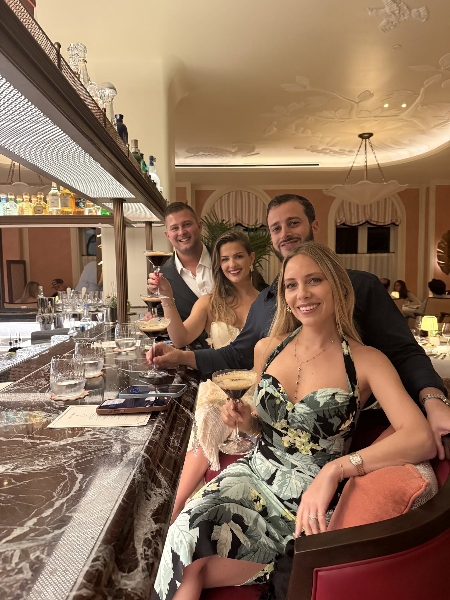 Friends enjoying espresso martinis at the beautiful marble bar at The Chesterfield Hotel