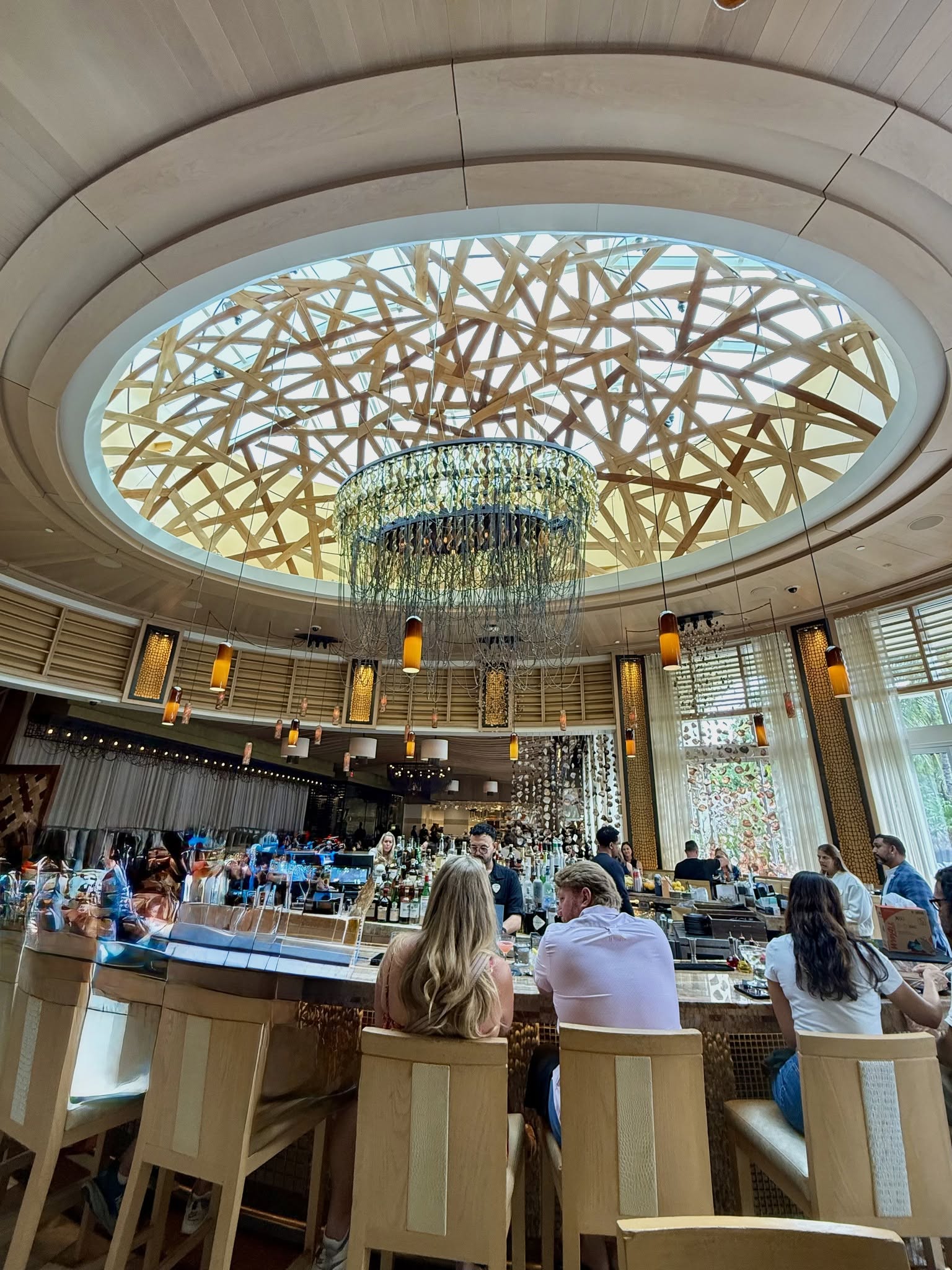 Interior of Kuro Japanese restaurant featuring dramatic wooden lattice ceiling and elegant chandelier