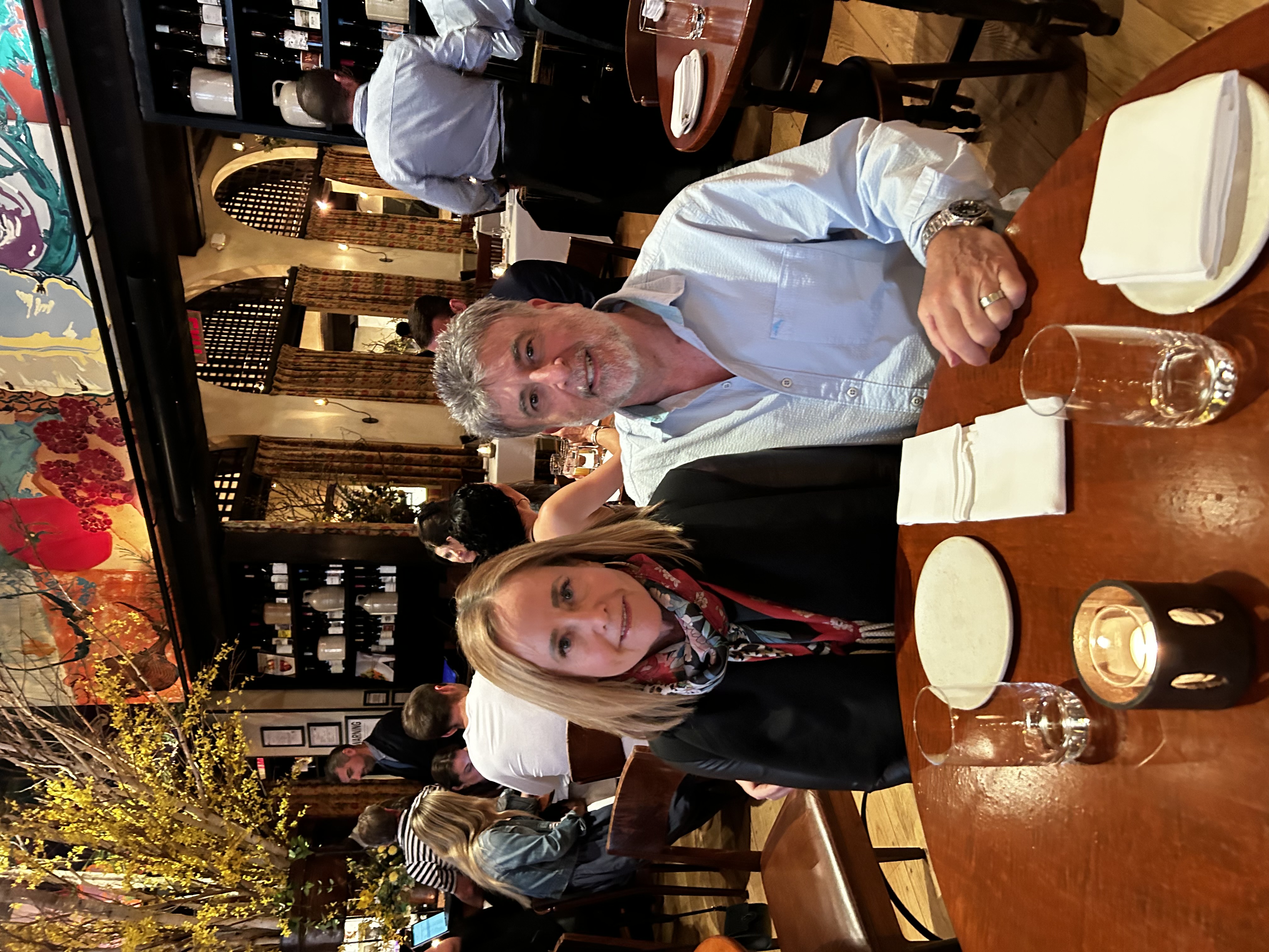 Dr Ira Pearlstine and his wife Amy Smith dining at a restaurant