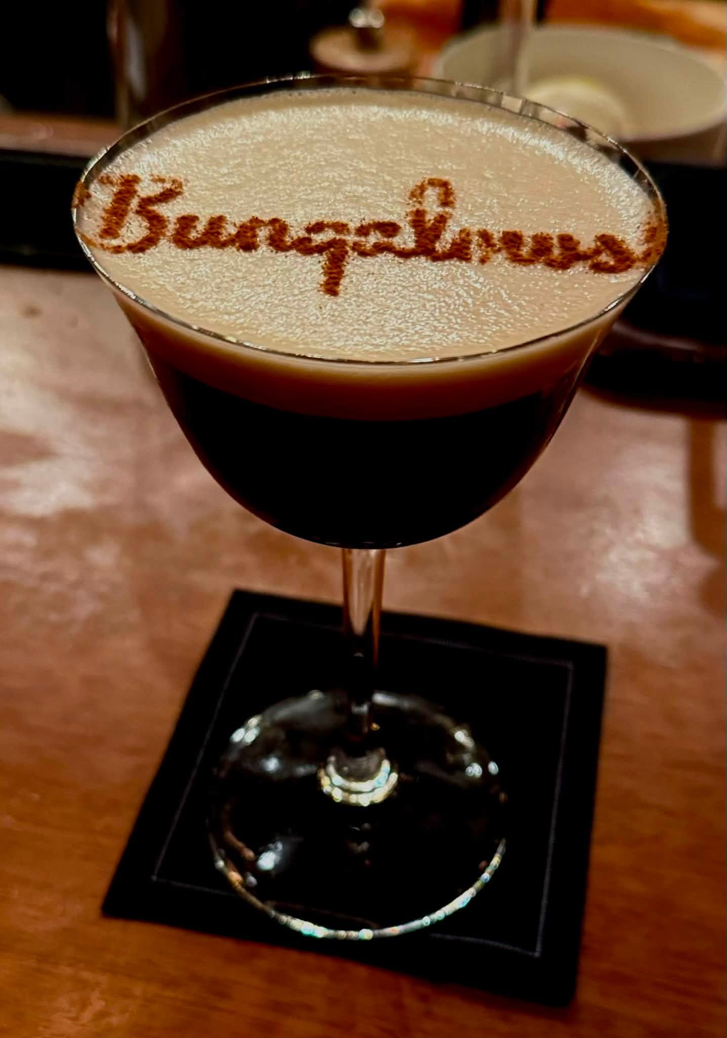 Bungalows signature cocktail with 'Bungalows' written in cinnamon on the foam