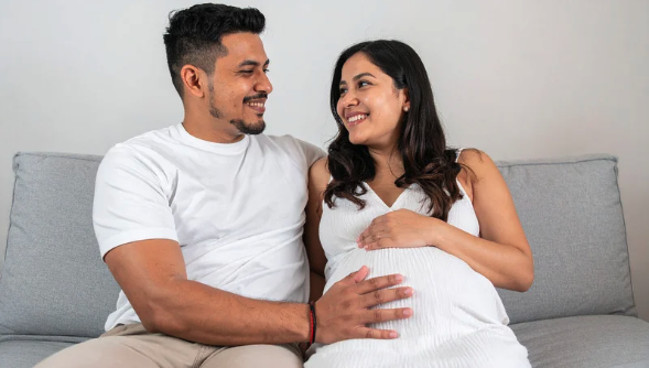 Expectant parents sitting together and preparing as a team for their baby.