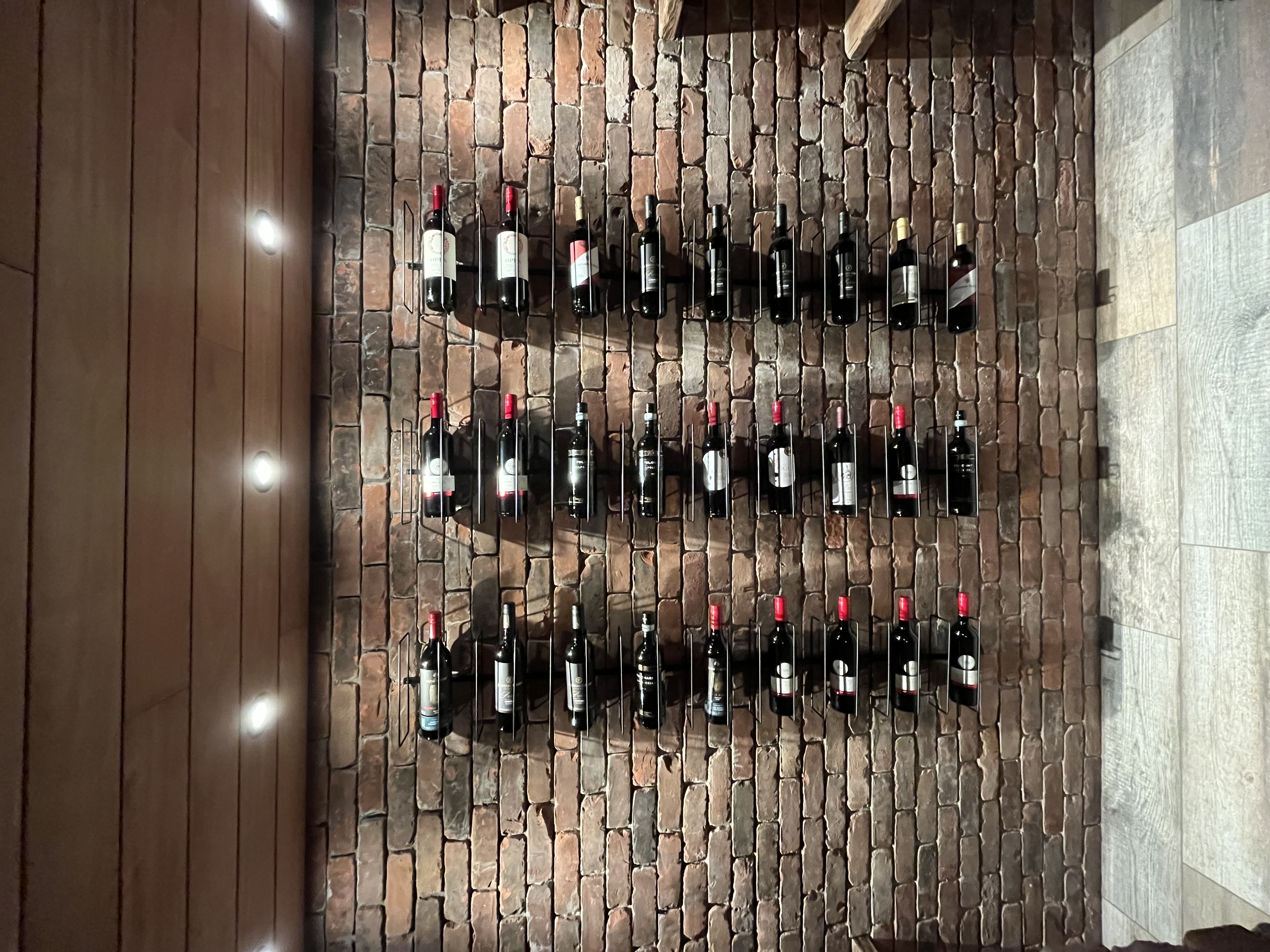 Custom brick wine cellar with reclaimed brick and shelving