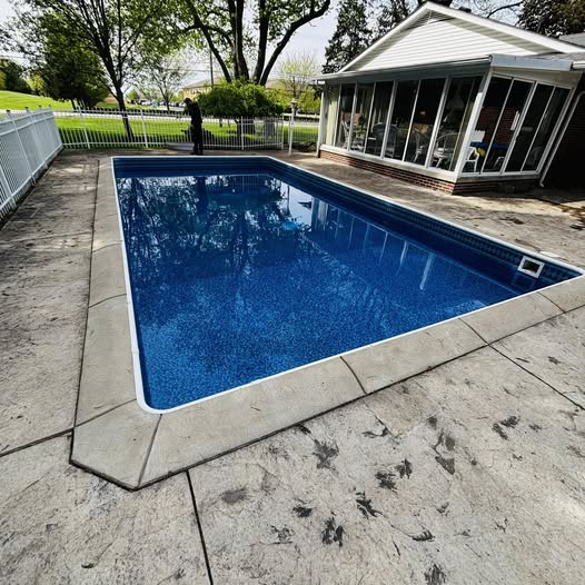 Beautiful inground pool installation with custom concrete deck