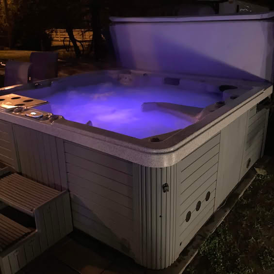 Hot tub at night with purple LED lighting