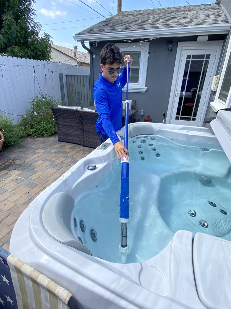 Standalone backyard spa with freshly balanced, clear water after a maintenance visit