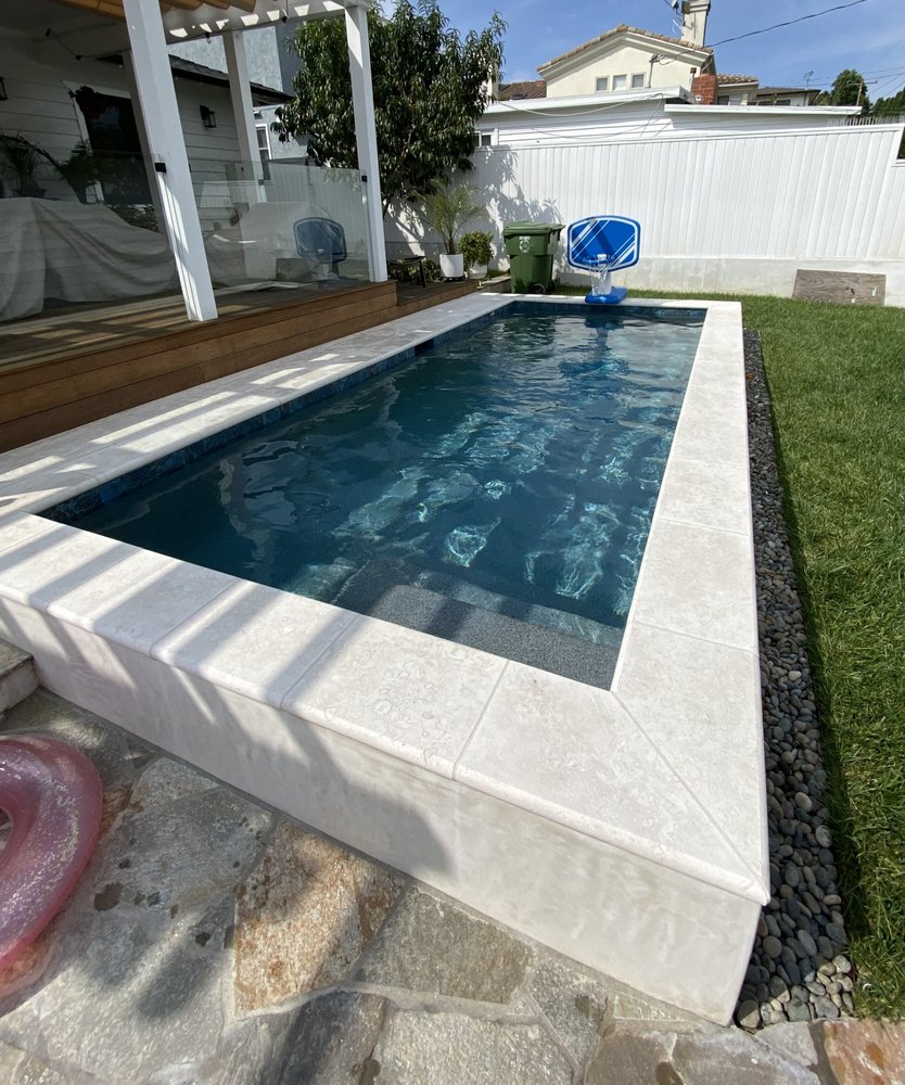 Small plunge spa with clean, balanced water in a compact backyard