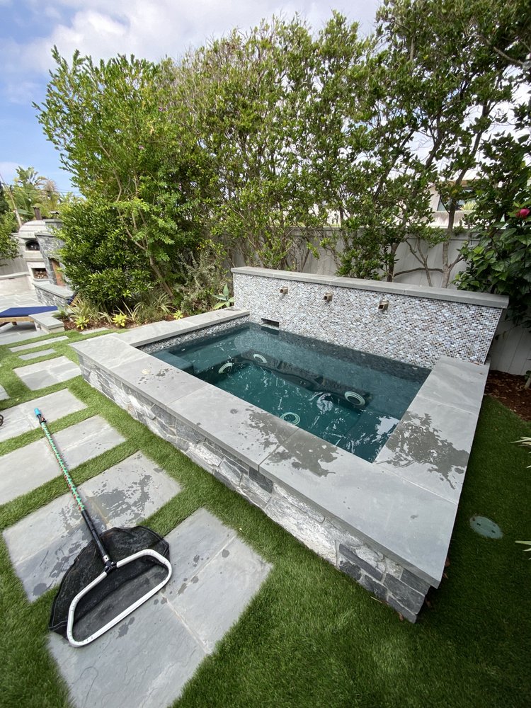 Custom in-ground spa with clean tile and clear water in a South Bay home