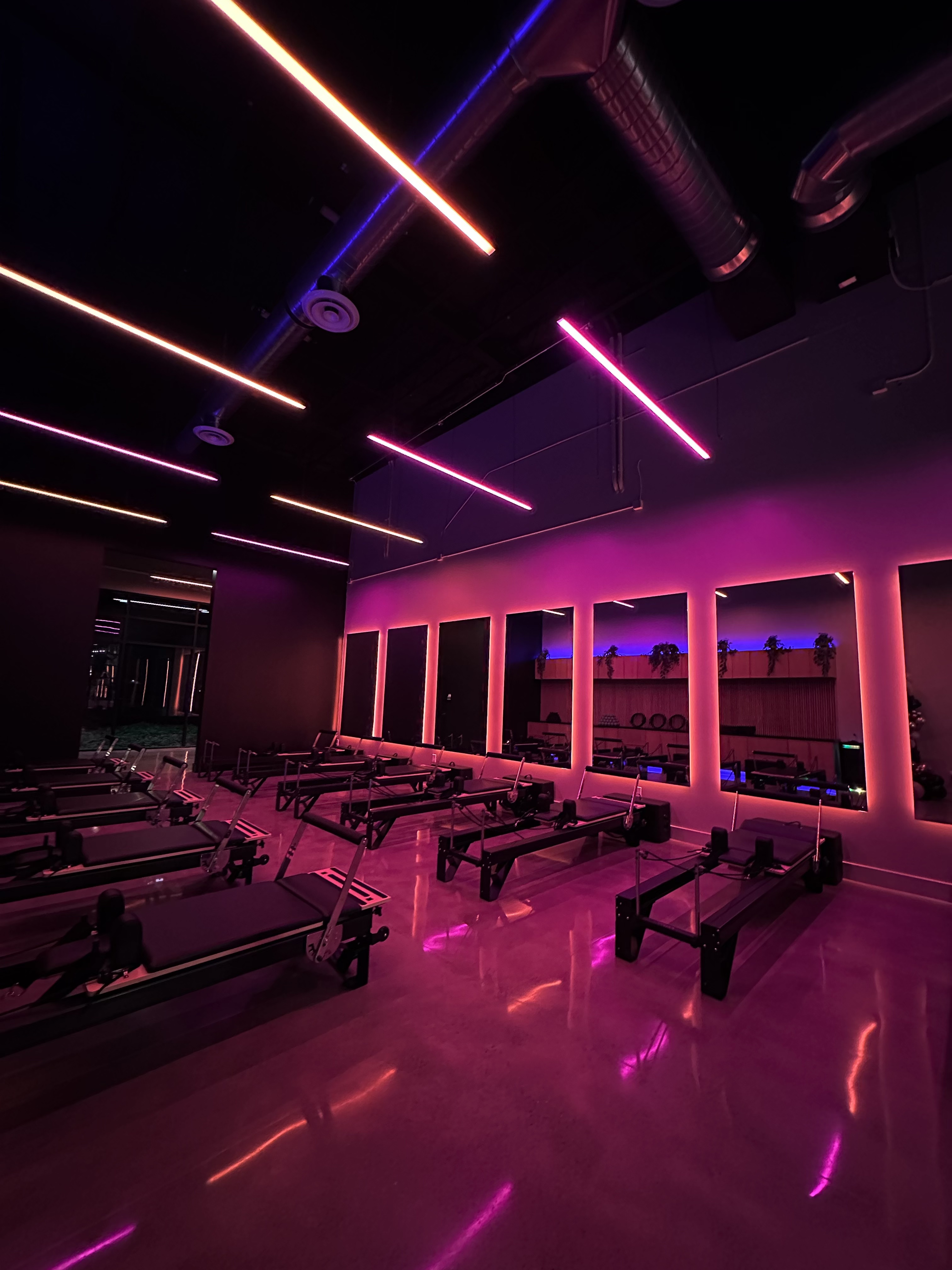 Endure Pilates Studio with custom neon mood lighting and reformers