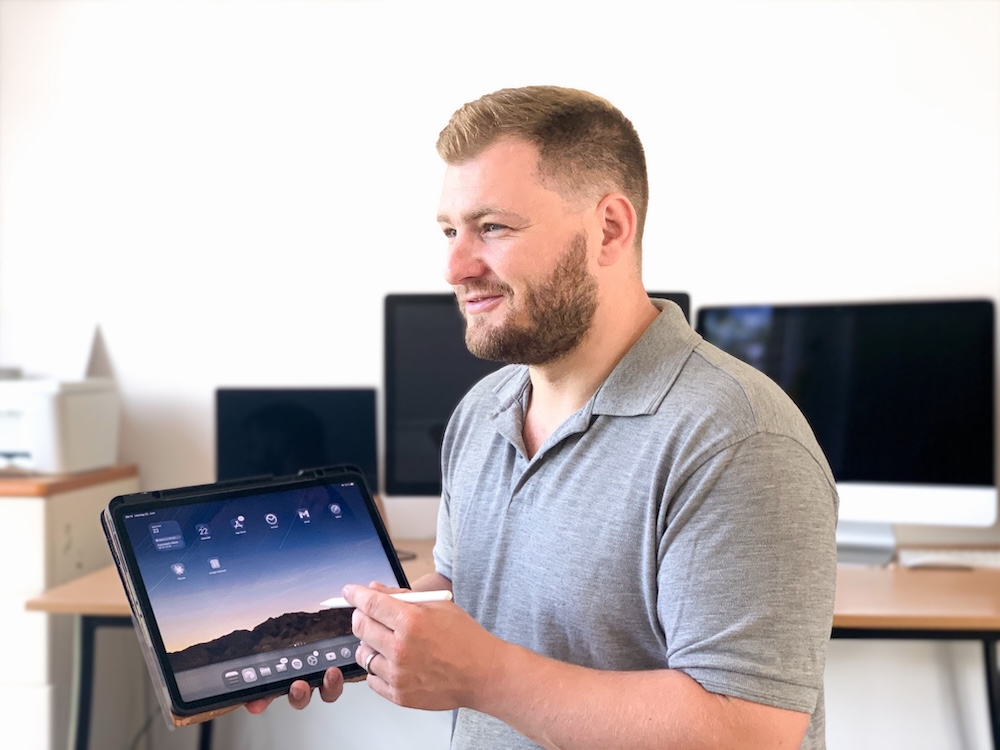 Ben Seidel zeigt einem Kunden die neue Website auf einem Tablet