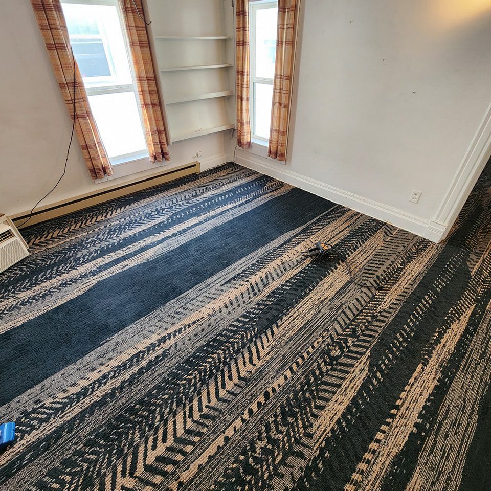 Professional carpet installation — careful stretching and seaming