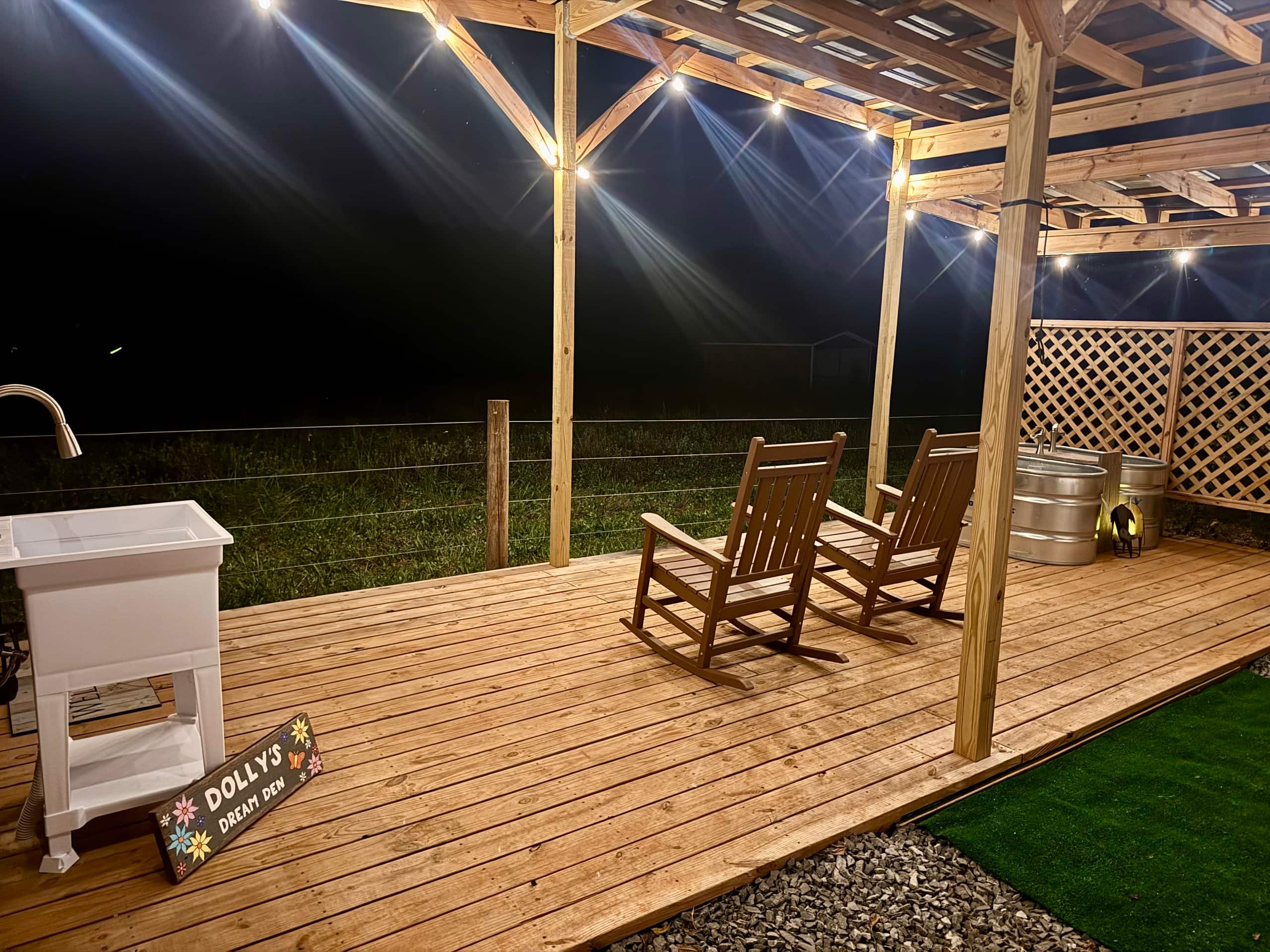 Private wooden patio deck with string lights at Faith Farm