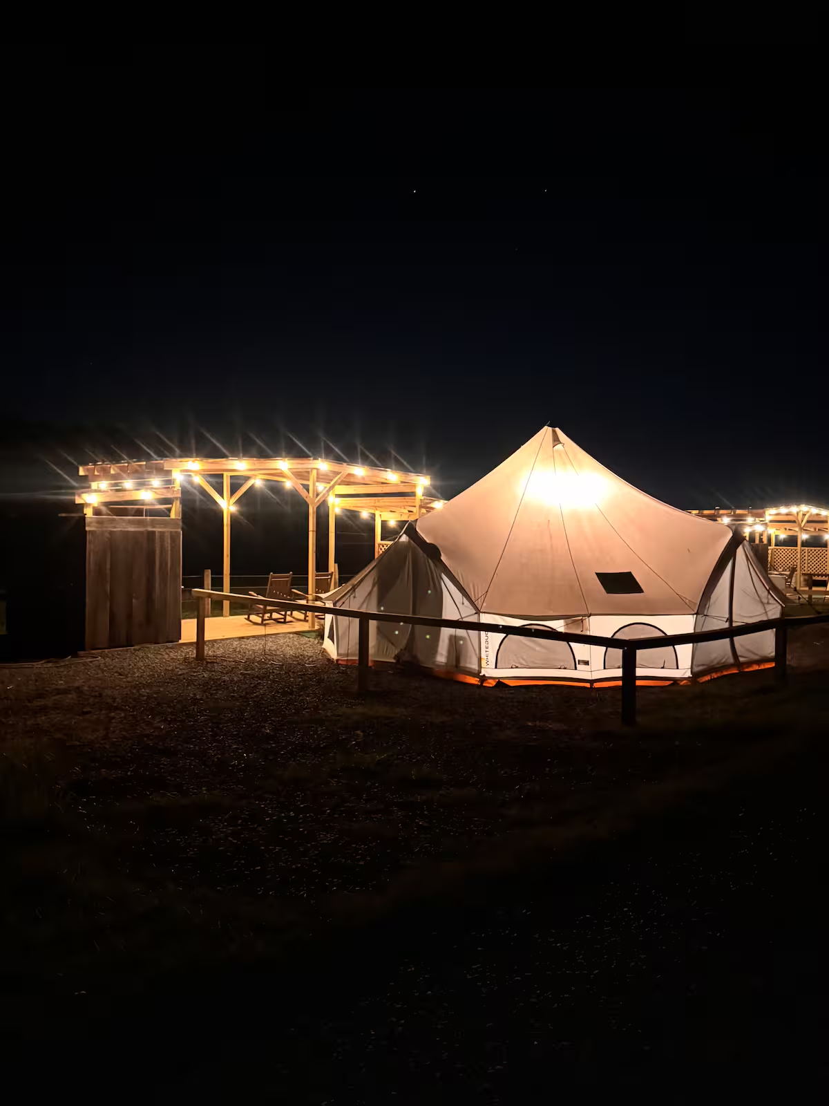 Dolly's Dream Den glamping tent illuminated at night at Faith Farm in Church Hill, Tennessee