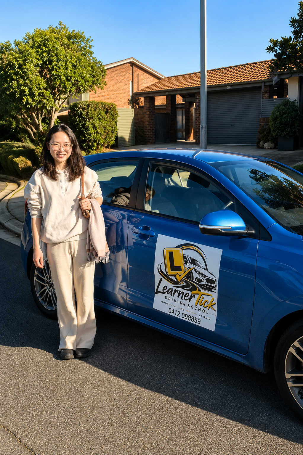 Student next to the Learner Tick Driving School car