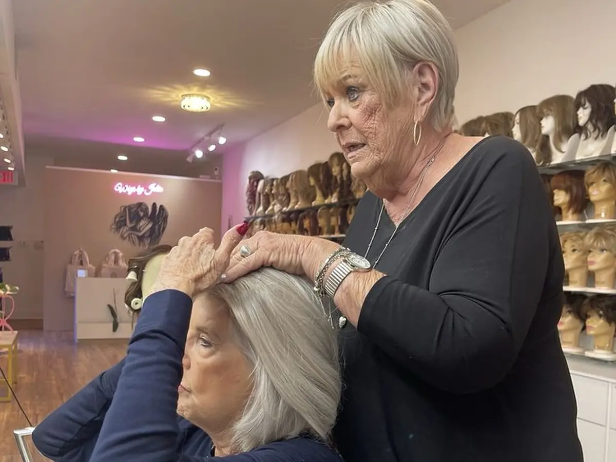Jolie fitting a client’s wig during a private boutique appointment.