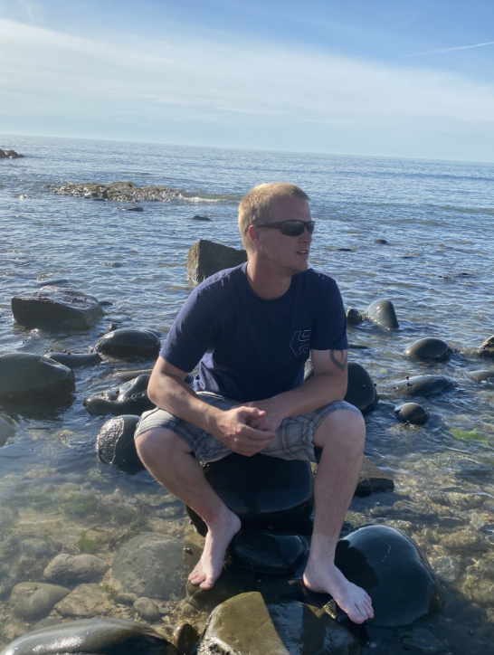 Daniel sitting on rocks