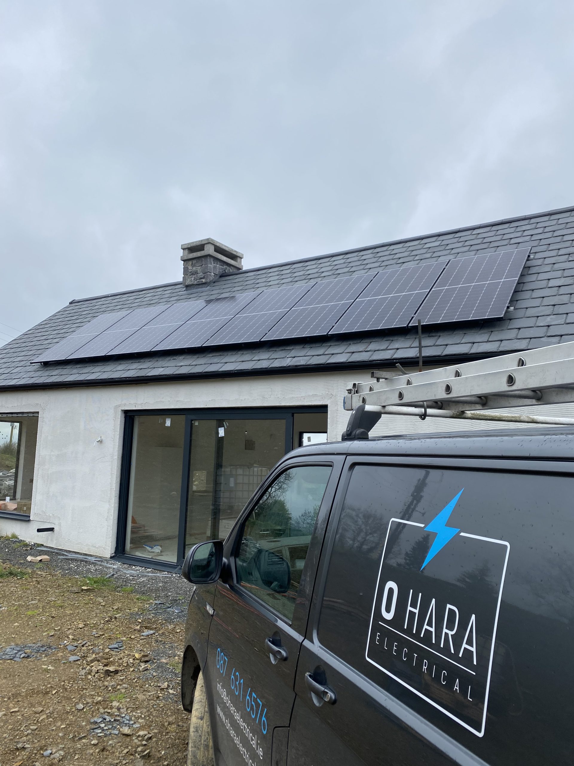 O'Hara Electrical van parked outside a new Irish home with solar panels on the roof