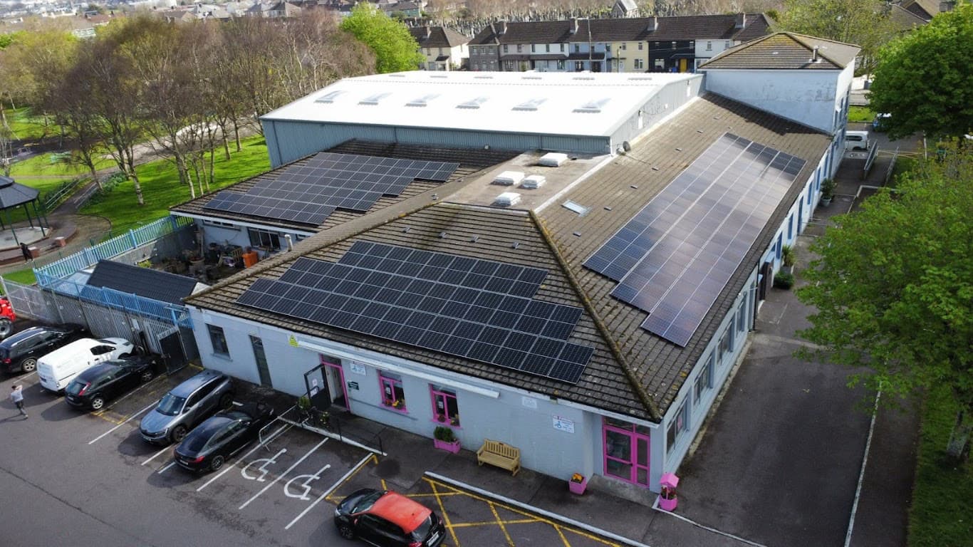Aerial view of community building with extensive solar PV installation