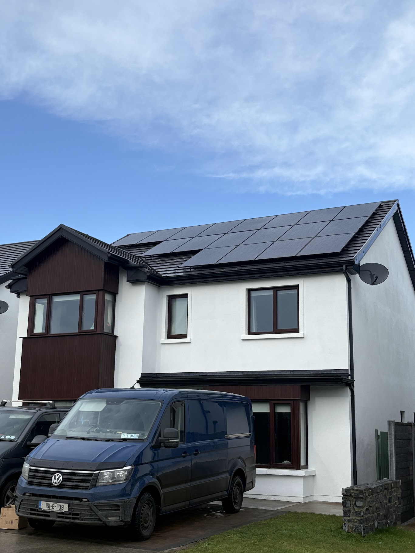O'Hara Electrical service van outside residential home with newly installed black solar PV panels