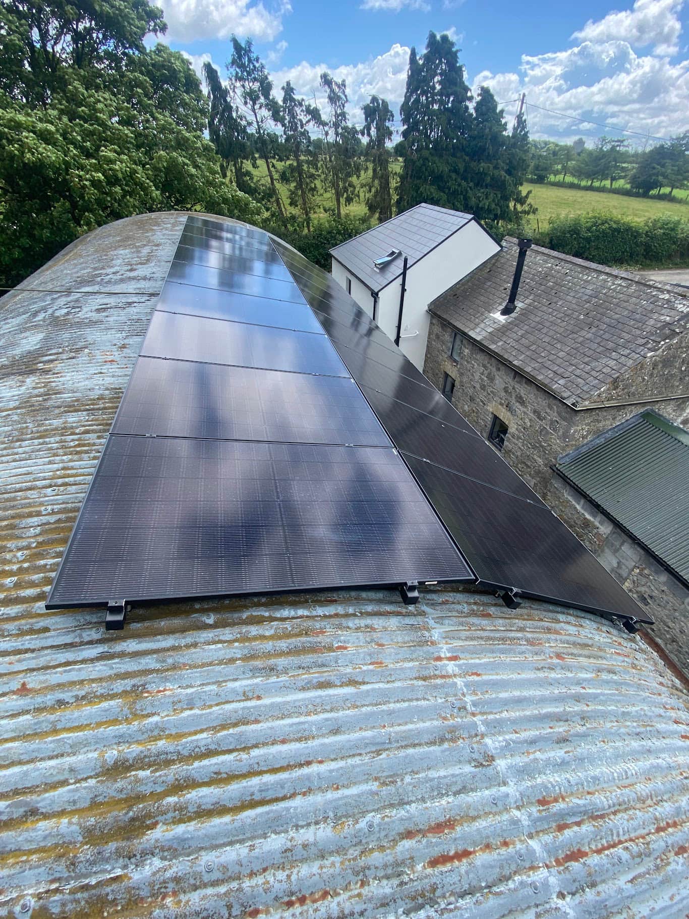 Curved agricultural corrugated barn roof fitted with solar PV panels