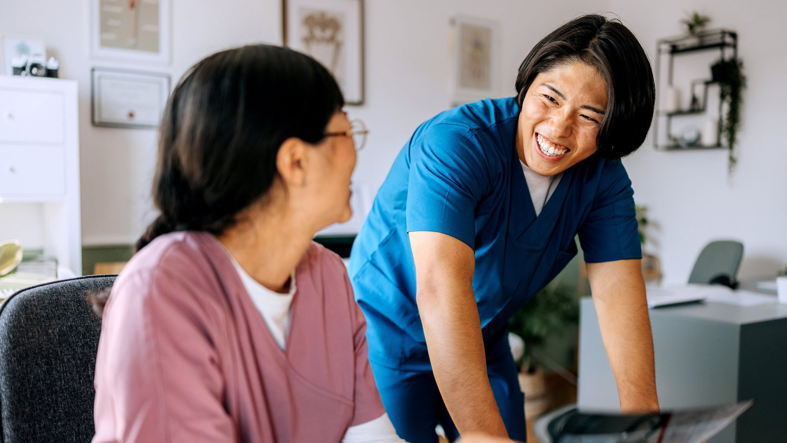 Clinicians reviewing records together in a practice office.